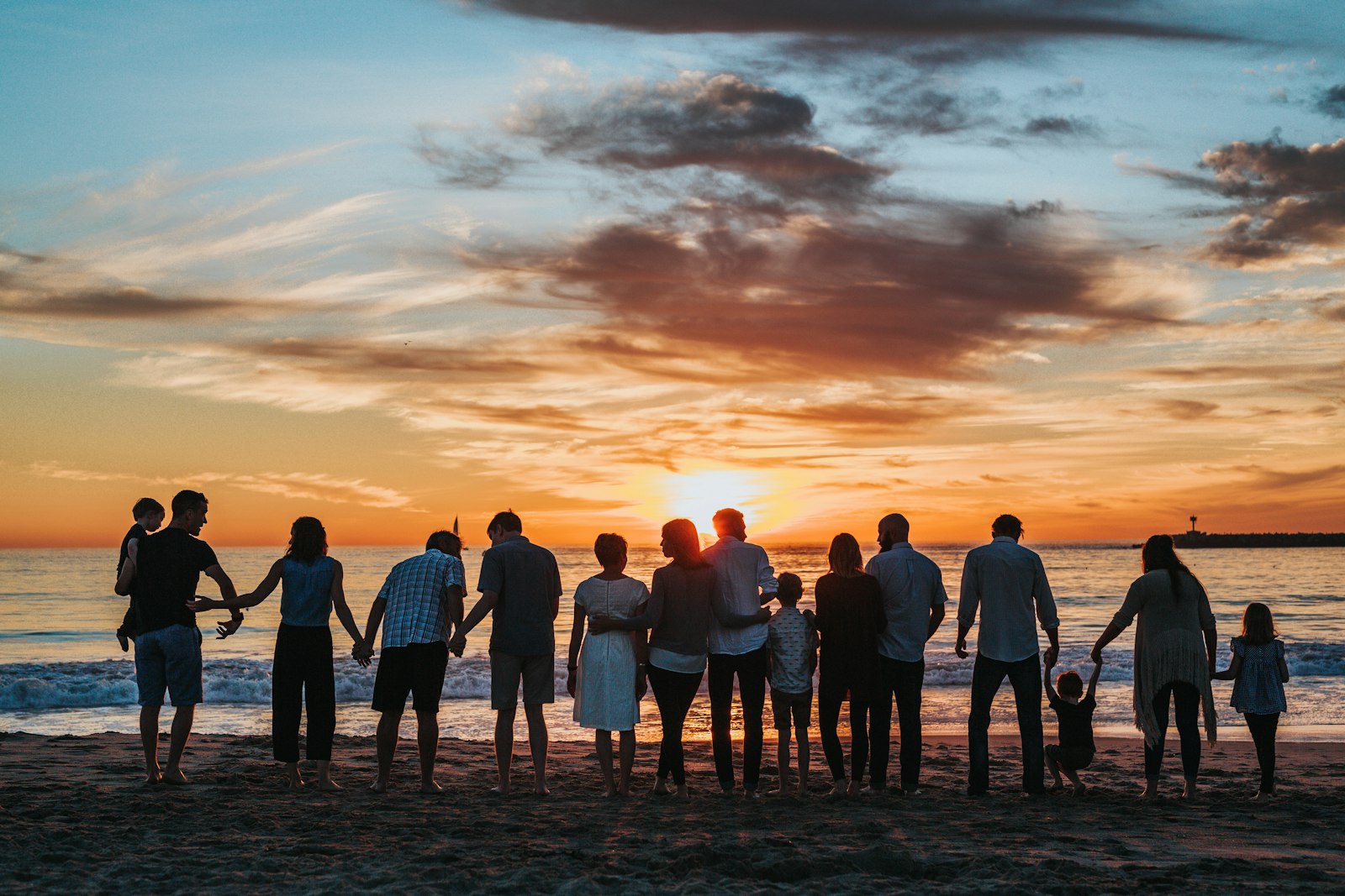 Familia unida tomada de la mano al atardecer
